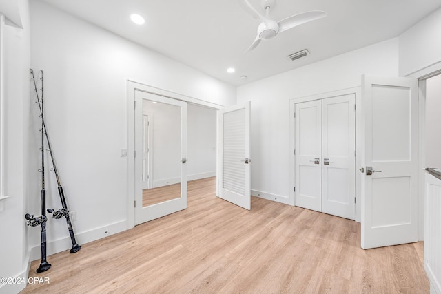 unfurnished bedroom featuring light wood-type flooring and ceiling fan