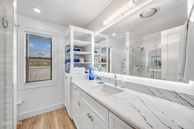 bathroom featuring vanity, wood-type flooring, and walk in shower