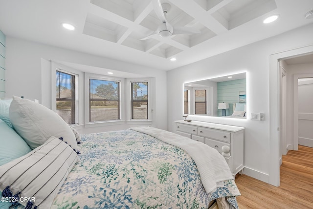 bedroom with ceiling fan, coffered ceiling, beam ceiling, and light wood-type flooring