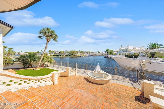 view of patio featuring a dock and a water view