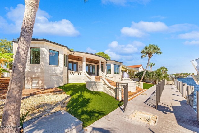 443 Wahoo Rd, Panama City Beach, FL 32408 - rear view of property featuring a yard, stairs, and brick siding