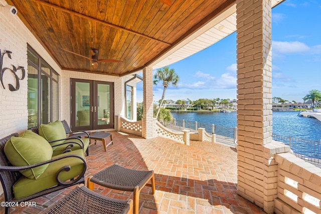 view of patio / terrace with a water view and ceiling fan