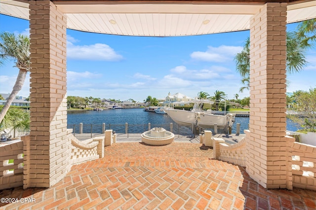 view of patio / terrace with a water view and a dock