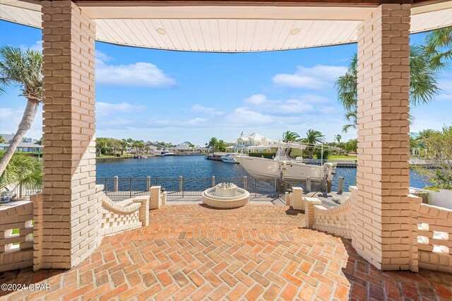 443 Wahoo Rd, Panama City Beach, FL 32408 - view of patio / terrace with a water view, a boat dock, and fence