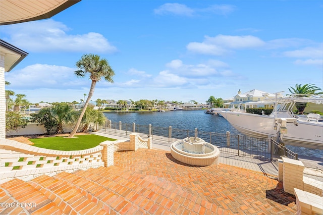 view of patio / terrace with a boat dock and a water view