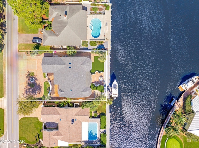 birds eye view of property with a water view