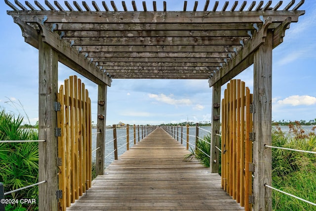 dock area with a pergola and a water view