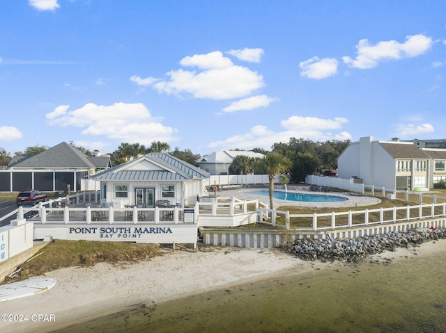 443 Wahoo Rd, Panama City Beach, FL 32408 - back of house with a community pool, metal roof, a deck, and a standing seam roof