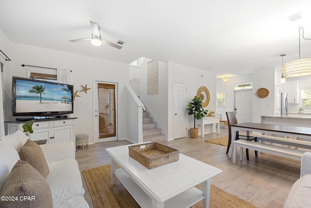 living room with ceiling fan and light hardwood / wood-style floors