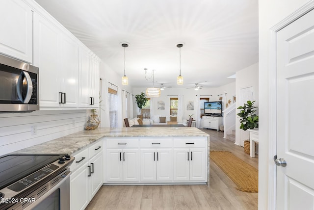 kitchen featuring kitchen peninsula, appliances with stainless steel finishes, light hardwood / wood-style flooring, white cabinetry, and hanging light fixtures