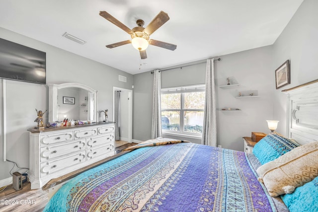 bedroom with hardwood / wood-style flooring and ceiling fan