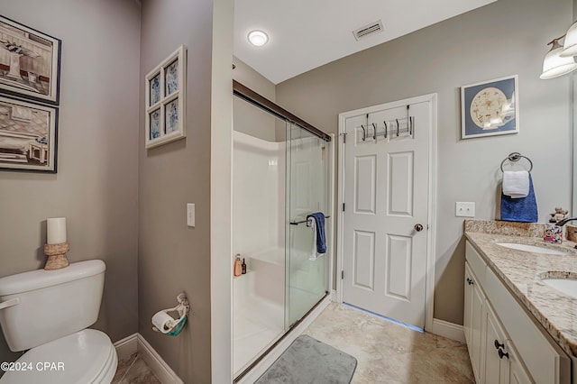 bathroom with tile patterned flooring, vanity, toilet, and a shower with shower door