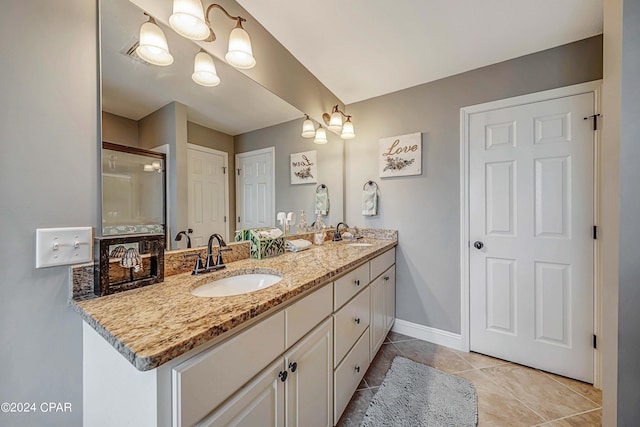 bathroom featuring tile patterned flooring, vanity, and a shower with shower door