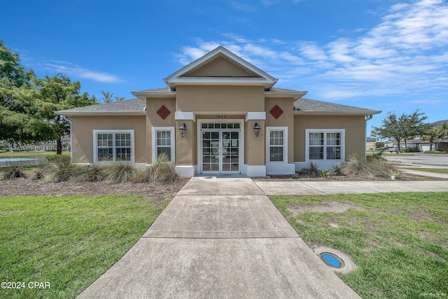 view of front of property featuring french doors and a front yard