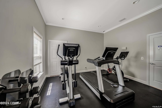 exercise area featuring crown molding