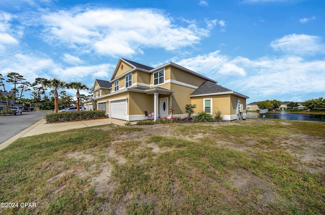 view of front of home featuring a garage and a water view