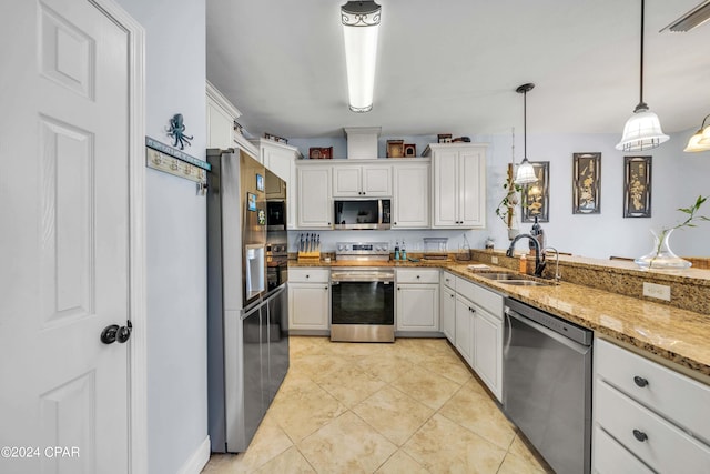 kitchen featuring stainless steel appliances, white cabinetry, light stone countertops, hanging light fixtures, and sink