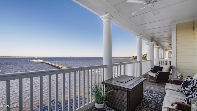 balcony with a ceiling fan and a water view