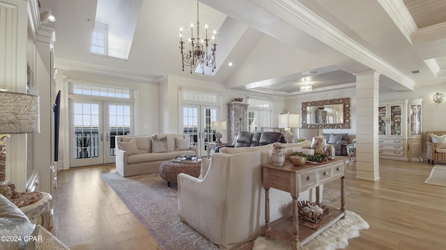 living room featuring ornamental molding, french doors, light wood-style floors, a high ceiling, and ornate columns