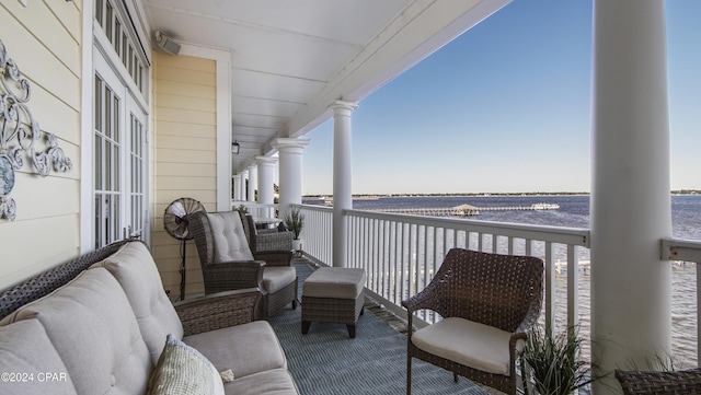 balcony featuring outdoor lounge area and a water view