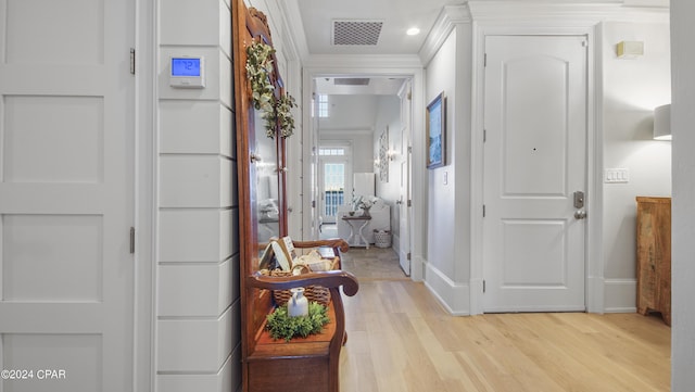 foyer with visible vents, ornamental molding, recessed lighting, light wood finished floors, and baseboards