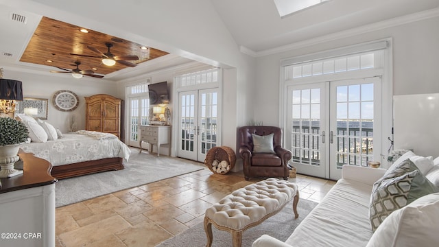 bedroom featuring french doors, a raised ceiling, ornamental molding, and access to outside