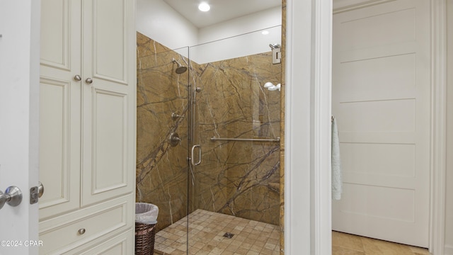 bathroom featuring a marble finish shower