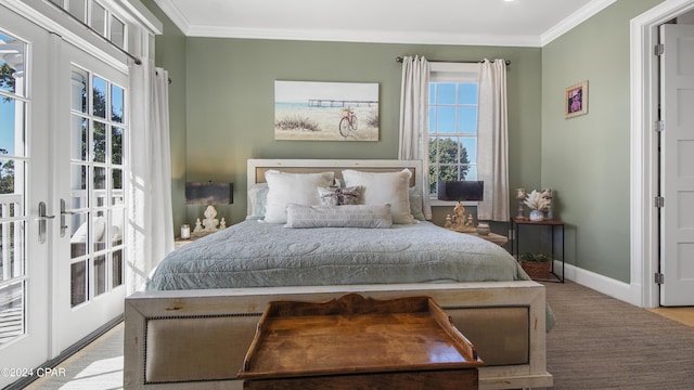 bedroom with french doors, crown molding, and baseboards