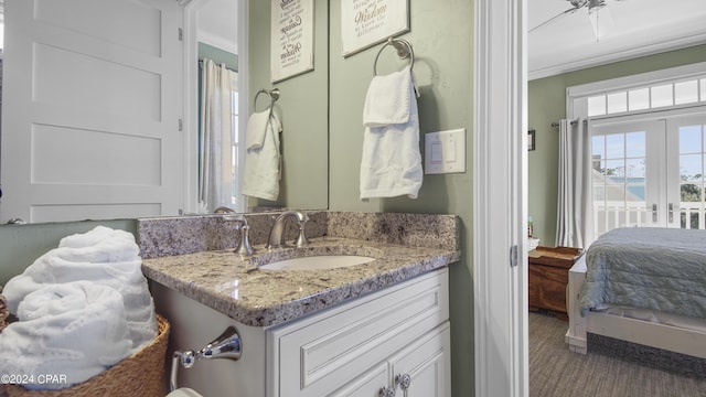 full bath featuring vanity, french doors, and ornamental molding