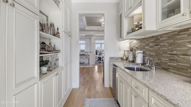 kitchen featuring light wood-style flooring, dishwasher, ornamental molding, and white cabinets