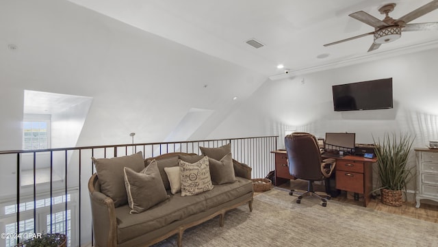 office area with wood finished floors, visible vents, ornamental molding, ceiling fan, and vaulted ceiling