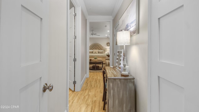 hall featuring crown molding and light wood-style flooring