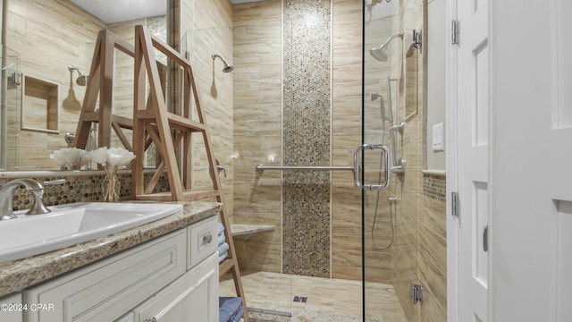 bathroom featuring vanity, tasteful backsplash, and a stall shower