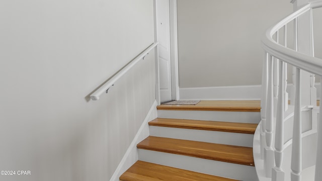 stairway featuring wood finished floors