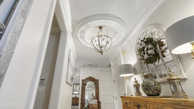 hallway featuring an inviting chandelier and ornamental molding