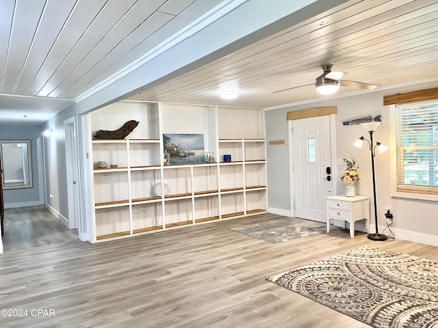 foyer entrance with crown molding, ceiling fan, wood-type flooring, and wooden ceiling