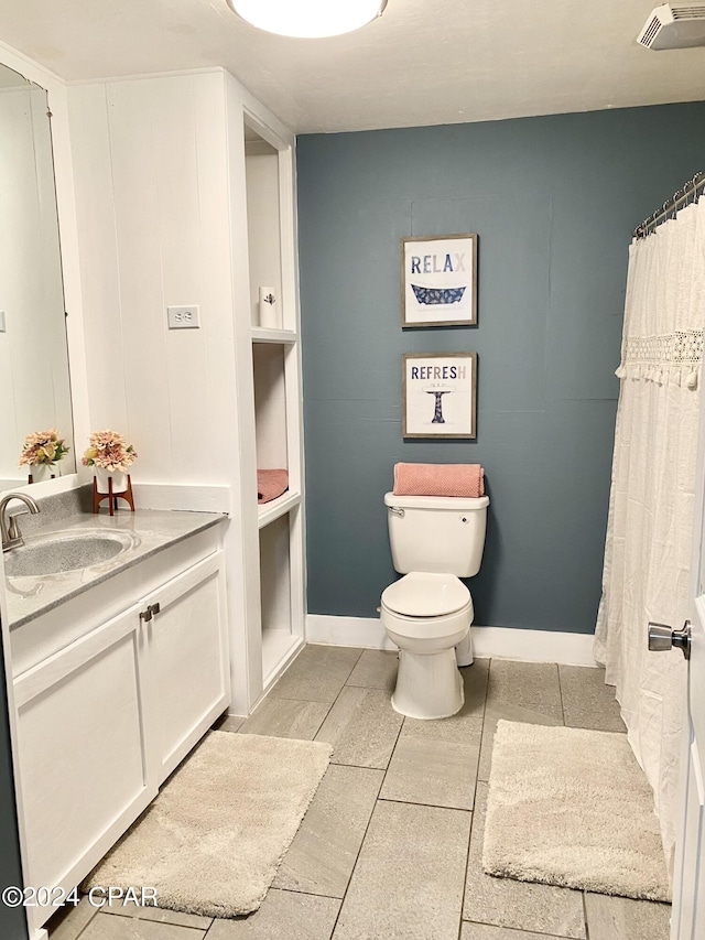 bathroom featuring vanity, toilet, and tile patterned floors