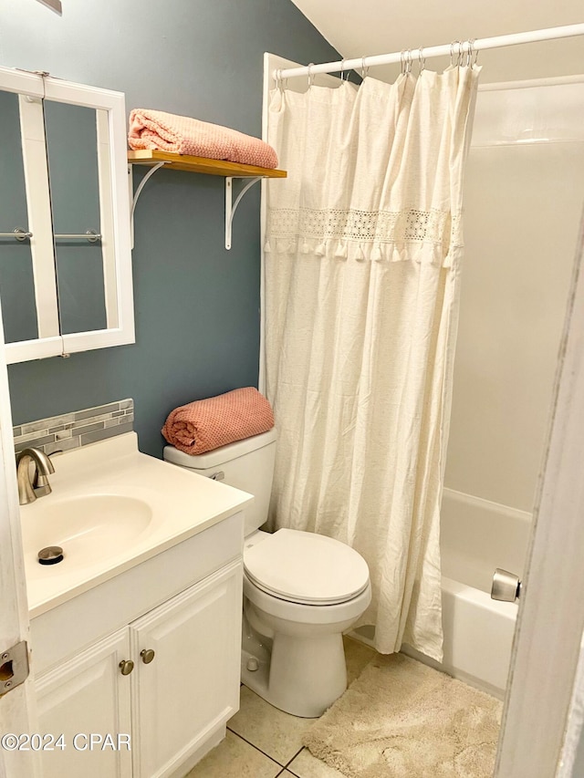 full bathroom featuring toilet, vanity, tile patterned floors, and shower / tub combo