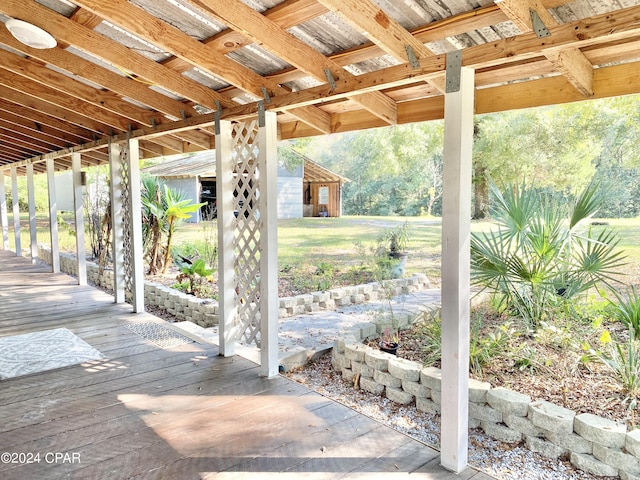 view of patio featuring a storage shed and a deck