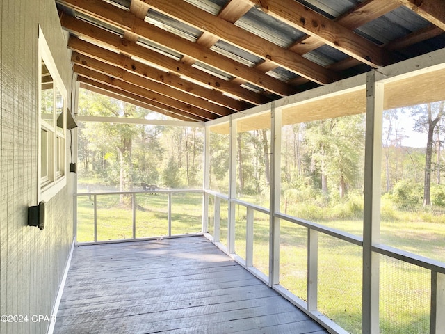 unfurnished sunroom featuring lofted ceiling and a wealth of natural light