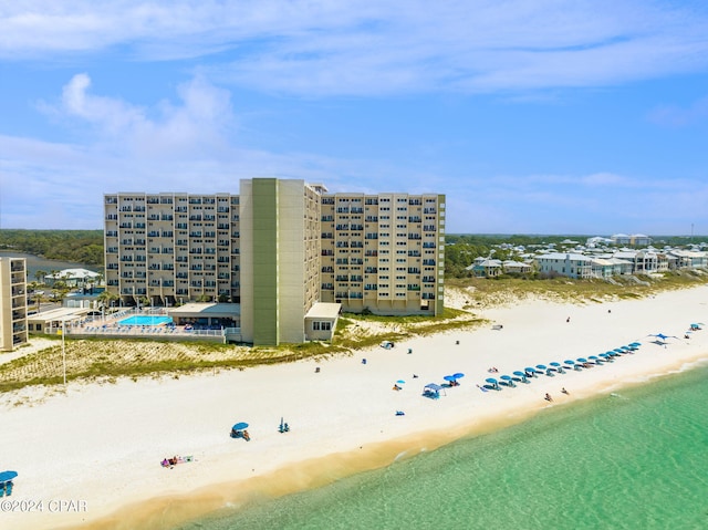 bird's eye view featuring a water view and a beach view