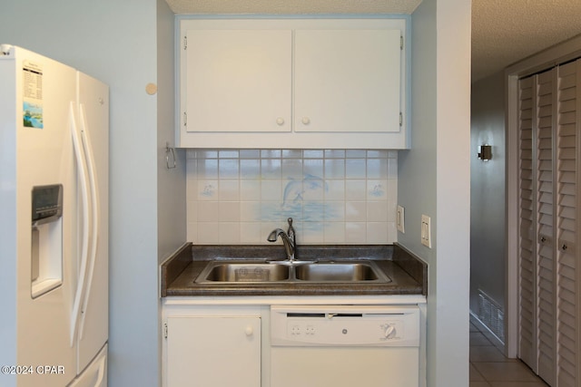 kitchen featuring decorative backsplash, white cabinets, a textured ceiling, and white appliances