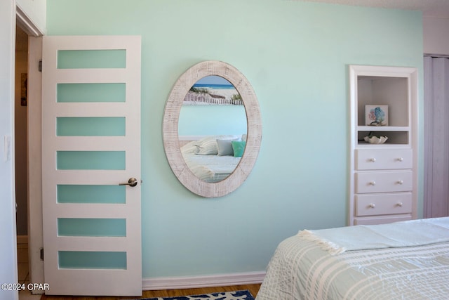 bedroom with wood-type flooring