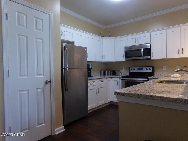 kitchen featuring light stone counters, appliances with stainless steel finishes, sink, and white cabinets