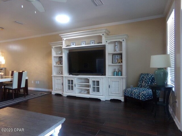 living room with dark wood-type flooring, crown molding, and ceiling fan