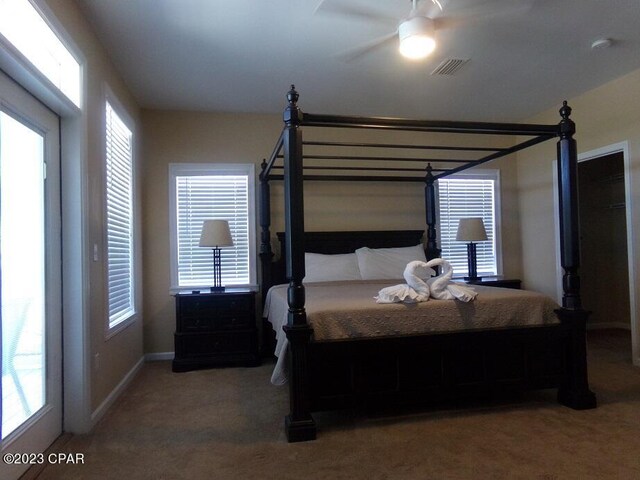 carpeted bedroom with ceiling fan and access to outside