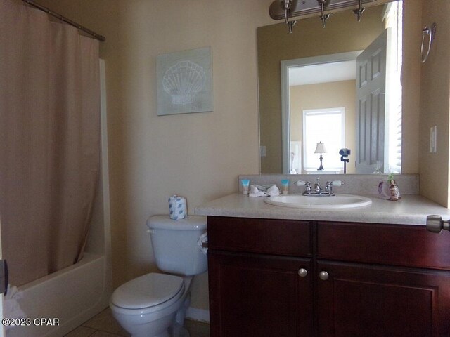 full bathroom with vanity, toilet, shower / bath combination with curtain, and tile patterned flooring