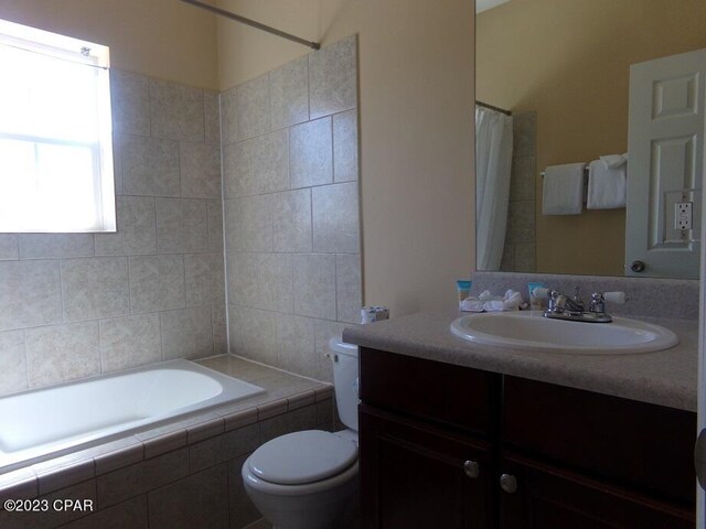 full bathroom featuring vanity, shower / bath combo, and toilet