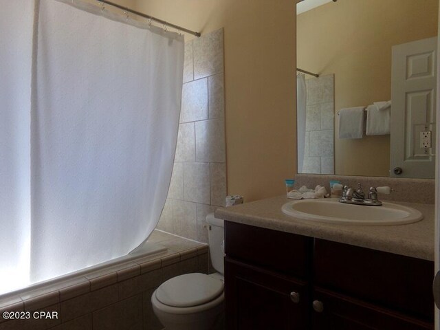 full bathroom featuring vanity, toilet, and shower / bath combo with shower curtain