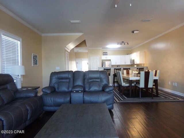 living room featuring crown molding and hardwood / wood-style flooring